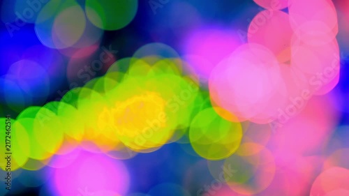 Dreamlike seasonal imagery combines a brightly illuminated Christmas tree, moving ornaments, colorful flashes, and soft glittering light effects to create a captivating festive backdrop.