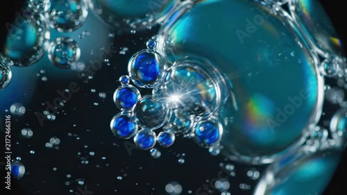 4k AI generated glowing blue oxygen bubbles float inside water macro shot