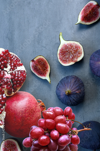 Fresh fruits mixed. Tasty fruits background, fig, grapes, pomegranate.