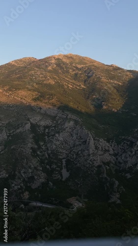 Scenic view of mountain range during golden hour with the upper peaks bathed in warm sunset light