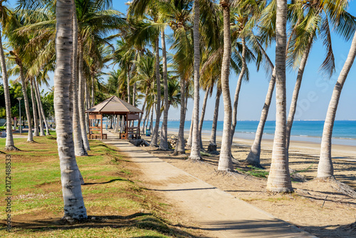 Coastal tourism destination in Muscat Oman featuring palm lined beach, seaside pavilion and tranquil tropical landscape