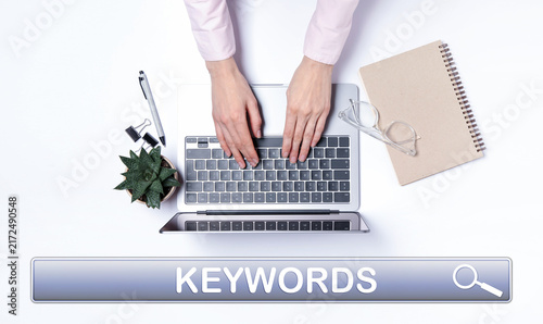 Fotografía Search bar for keywords and woman using laptop at desk, top view