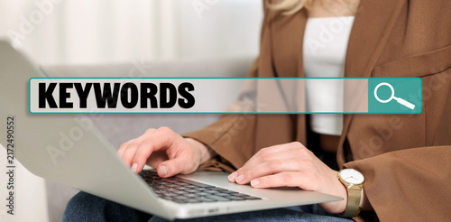 Fotografía Search bar for keywords and woman using laptop indoors, closeup