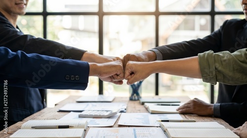 Business team standing with hands together for cooperation and success.