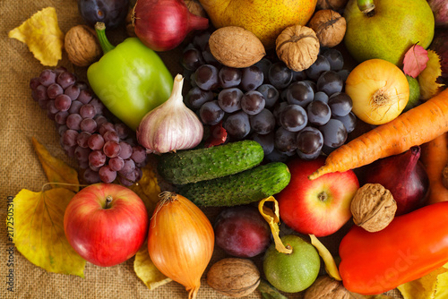 Obraz na płótnie Close up of abundant autumn harvest fruits vegetables and nuts on burlap