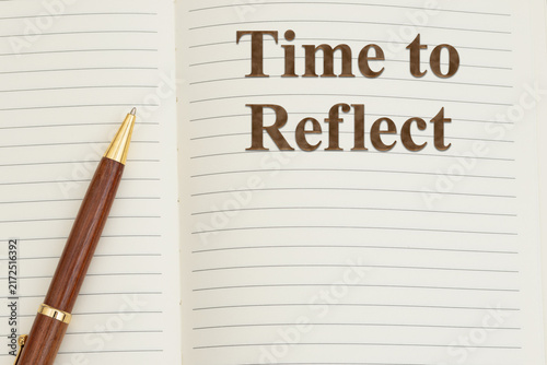 Time to reflect text on writing journal with a pen for journaling for self-care