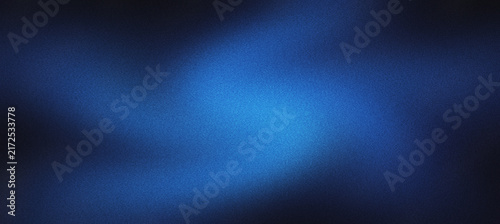 Abstract blue gradient background with grainy texture. Dark navy blue blurred backdrop for technology and corporate design. Soft glowing light effect on textured surface for web wallpaper.