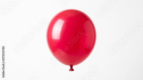 A vibrant red latex balloon floats against a plain white background with soft shadows.