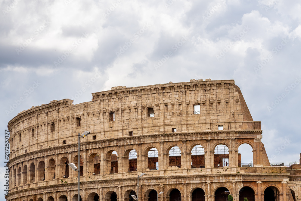 Fototapeta premium Famous tourist attraction of historic Colosseum amphitheatre with ancient stone arches in Rome Italy