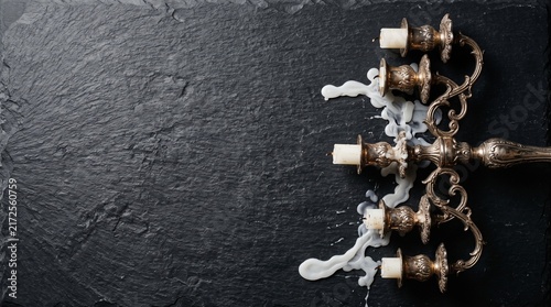 Silver baroque candelabra with melted wax cenital flat lay