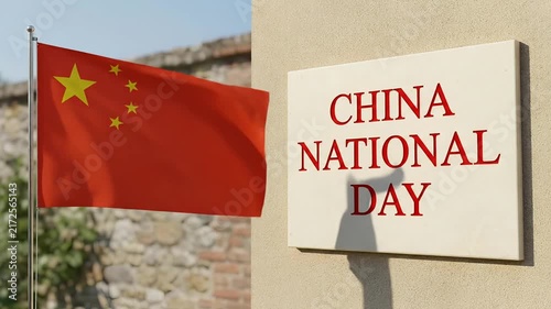 Waving Flag of China Next to a Plaque Celebrating China National Day