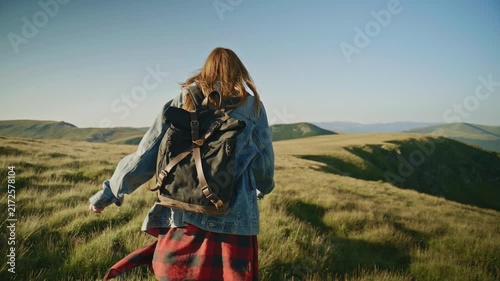 Walking through green hills in a countryside setting during a clear day