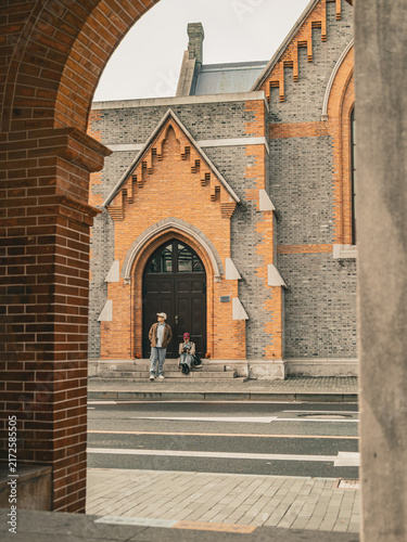 Photography Couple sitting together with camera on church steps, Union Church, Shanghai