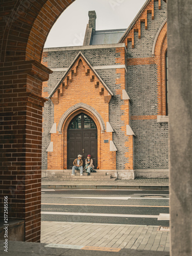 Photography Woman walking away from Union Church across the street, Shanghai