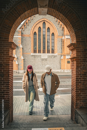 Photography Couple approaching camera through archway at Union Church, Shanghai