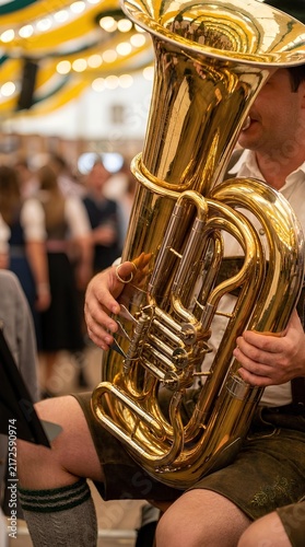 Musician playing large brass tuba at a traditional outdoor festival.