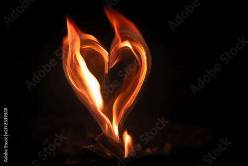 Heart of Flame: A vibrant heart shape formed by dancing flames against a dark, mysterious backdrop, symbolizing passion, love, and intense emotion.
