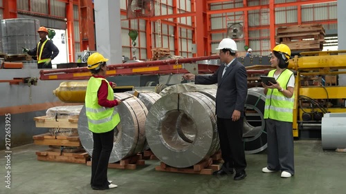 Engineers and staff are inspecting the assembly line system in a metal sheet and metal roofing manufacturing plant. (VDO 4K)	