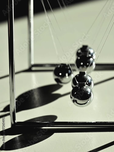 Newton's cradle out of sync video. Abstract concept for disruption, standing out, divergent, individuality, or differences. Human resources and corporate element.