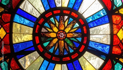 Radiant Circular Stained Glass Window with Vibrant Geometric and Floral Patterns