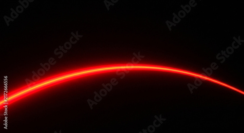 A striking image of a vibrant glowing red arc against a completely black dark background