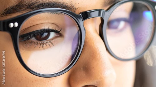 Eyes of a woman in glasses blinking, close-up view