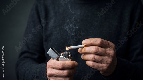 Close up of man hands lighting a cigarette with lighter stock photo