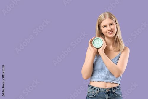 Canvastavla Time management and deadline pressure, young woman holding a clock to represent