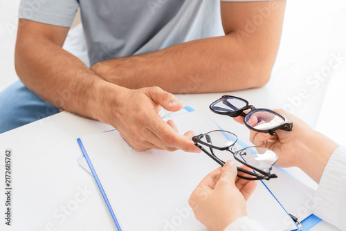 Konstfotografi Optometry consultation and vision care, patient choosing new eyeglasses with oph