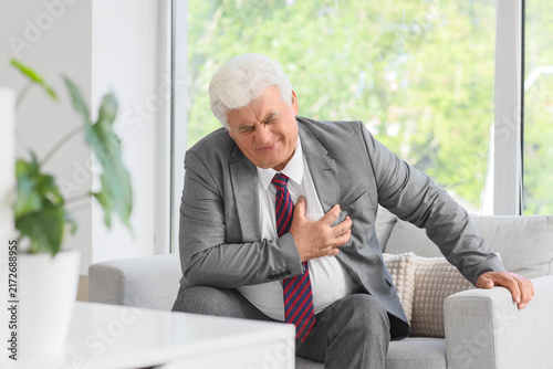 Quadro su tela Heart attack and chest pain, senior businessman suffering from sudden cardiac ar