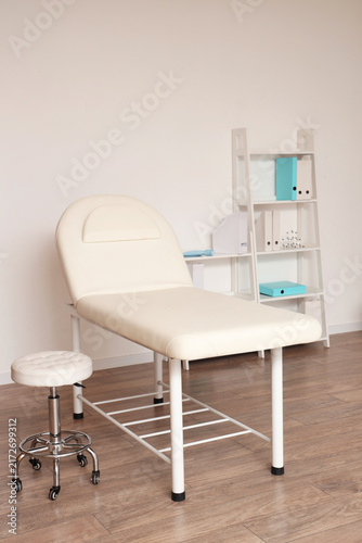 Interior of medical office with couch and shelf unit