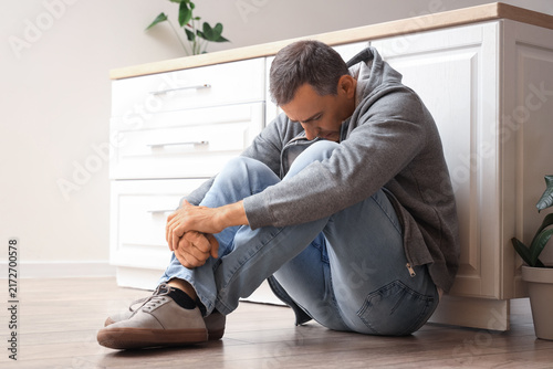 Mature man having panic attack in kitchen