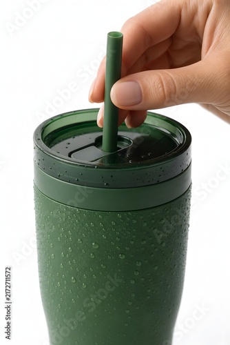 Hand Inserting Green Reusable Straw into Cold Tumbler
