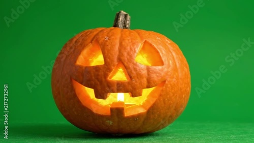 Carved Halloween Pumpkin Jack O Lantern Glowing On Green Screen Background.