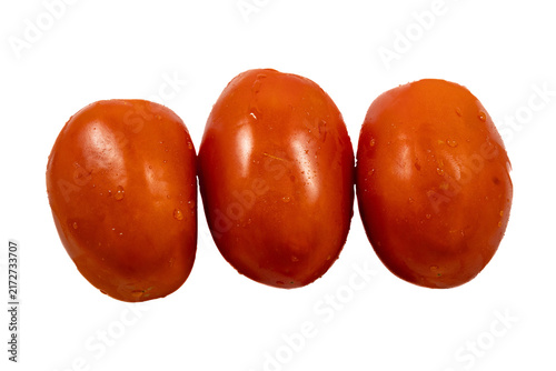 Cuadro en lienzo Three ripe, oblong roma tomatoes arranged in a horizontal row against a light, g