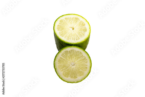 Two halves of a fresh green lime, stacked vertically, showing textured pulp and rind against a plain white background