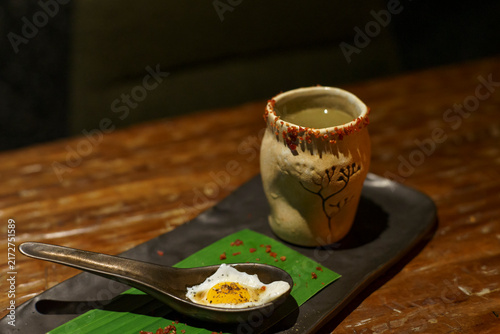 Canvastavla A glass of a unique cocktail Kaprao Moo Krob Kai Dao Mai Sook (crispy pork with