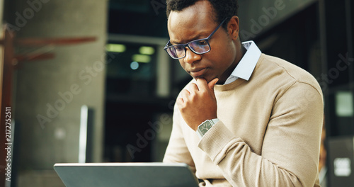 Canvastavla Thinking, business and black man in city with laptop, research and valuation report for real estate
