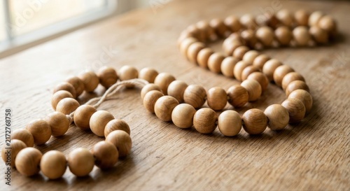 Smooth Polished Wooden Beads Strung Together on a Rustic Wooden Surface