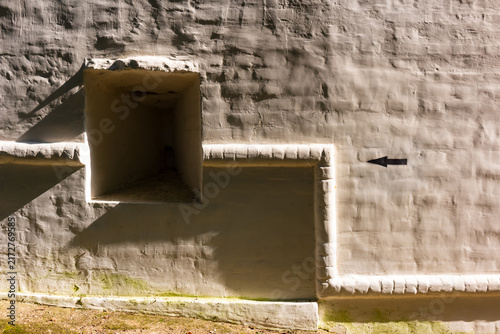 Konstfotografi Close-up view of an ancient white-washed monastery fortress wall featuring a dee