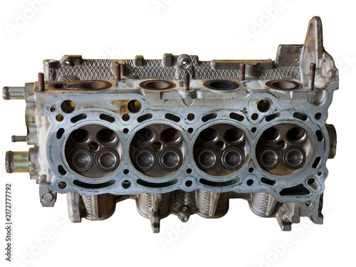 Metallic car engine cylinder head block showing internal combustion chambers and valves