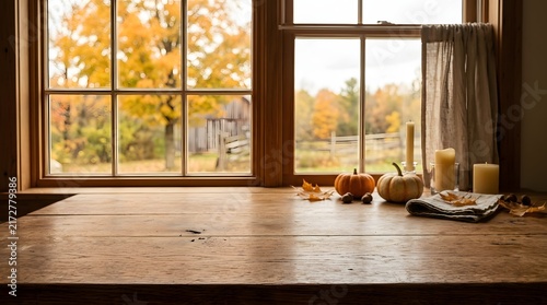Thanksgiving day wooden countertop with autumn window view pumpkins candles fall scenery pumpkins
