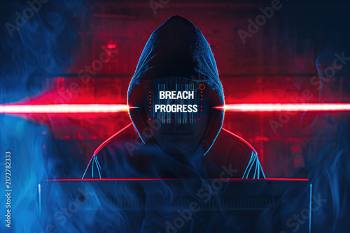 Silhouette of Hooded Cyber Intruder Displaying Breach Warning Against Split Color Wall