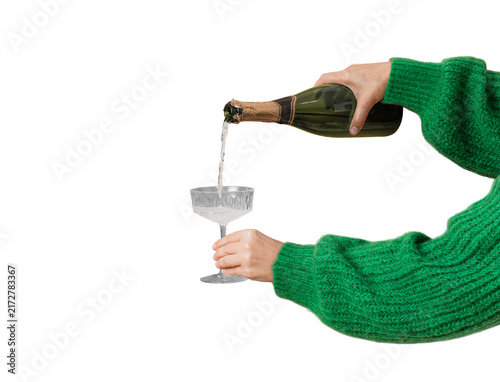 Concept for Christmas party, female hand pouring champagne, wine into glass on isolated transparent background. Festive background of Christmas party