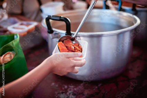 hands of the poor receive food from the donor's share , Feeding the poor to help and share