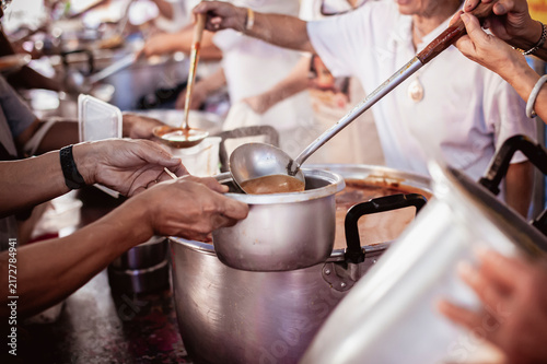 hands of the poor receive food from the donor's share , Feeding the poor to help and share