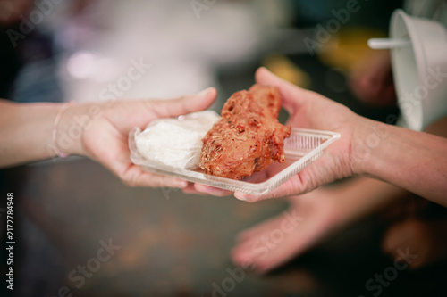 hands of the poor receive food from the donor's share , Feeding the poor to help and share