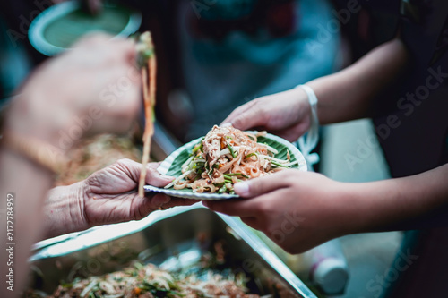 hands of the poor receive food from the donor's share , Feeding the poor to help and share