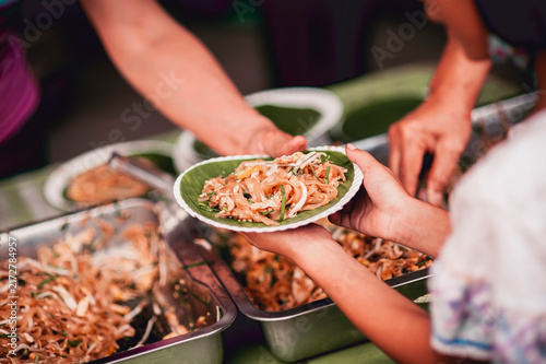 hands of the poor receive food from the donor's share , Feeding the poor to help and share