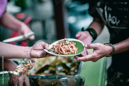 hands of the poor receive food from the donor's share , Feeding the poor to help and share